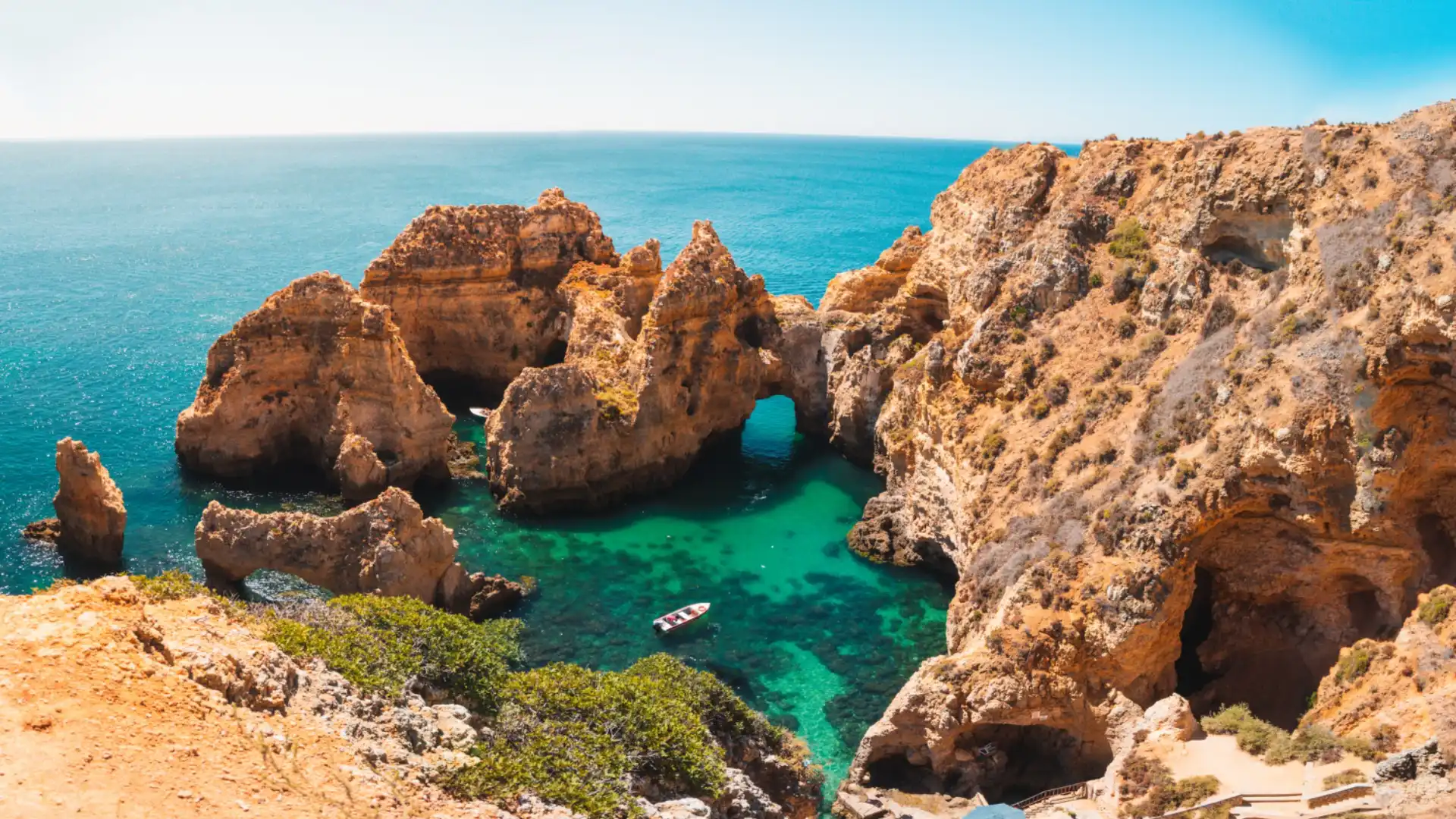 35836 Scenic cliffs and turquoise sea with small boat